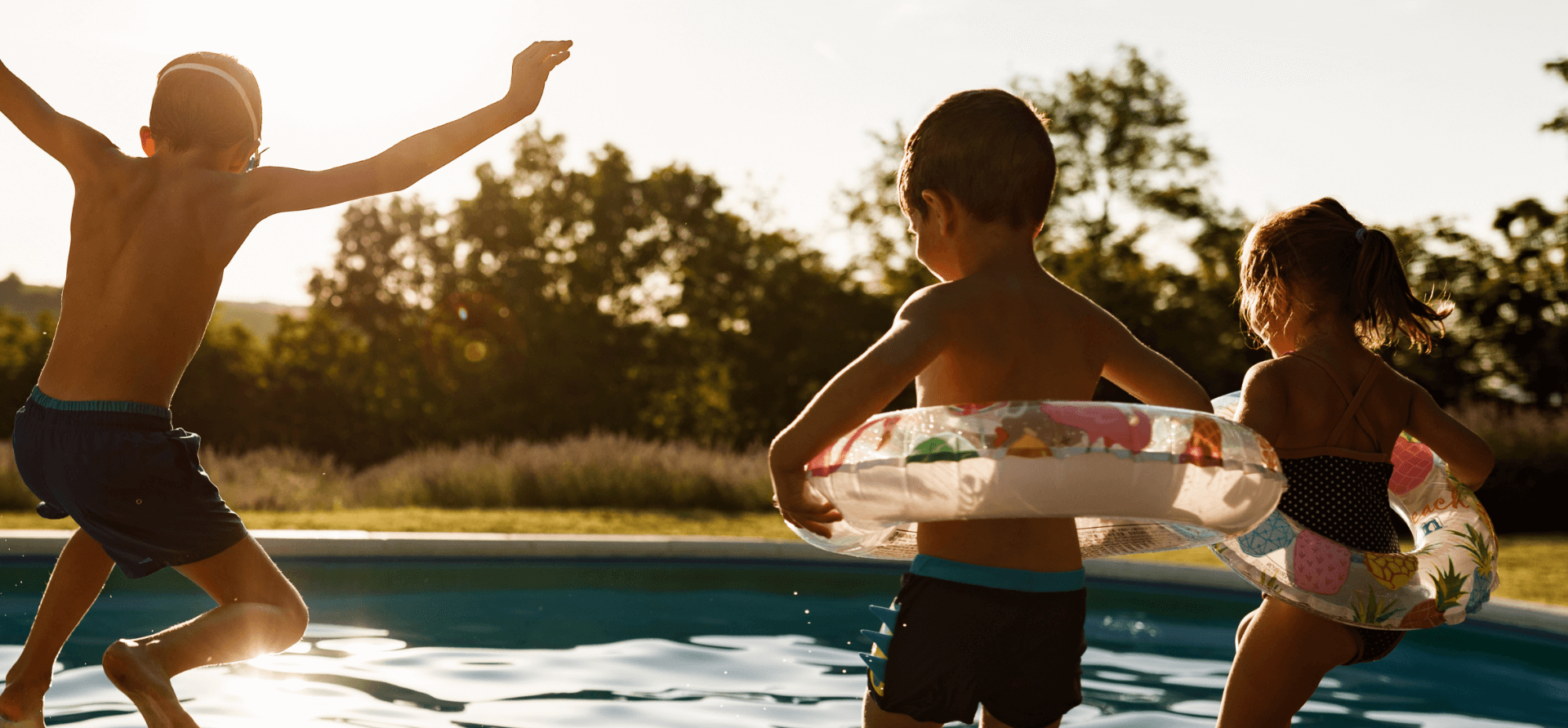 Playful kids having fun during a summer day at the pool.