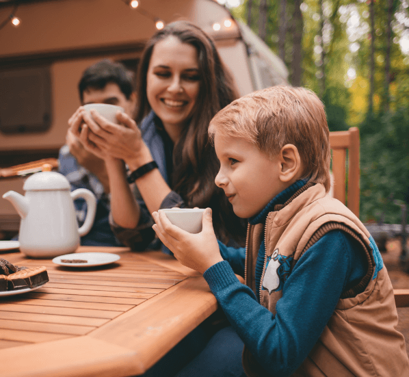 Happy family on a camping trip in the autumn forest.