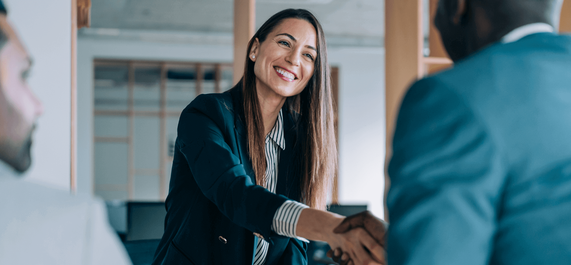 People shaking hands in an office.