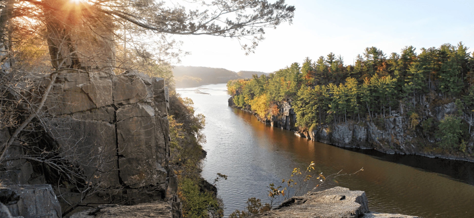 Autumn sunset from a tall cliff overlooking a river.