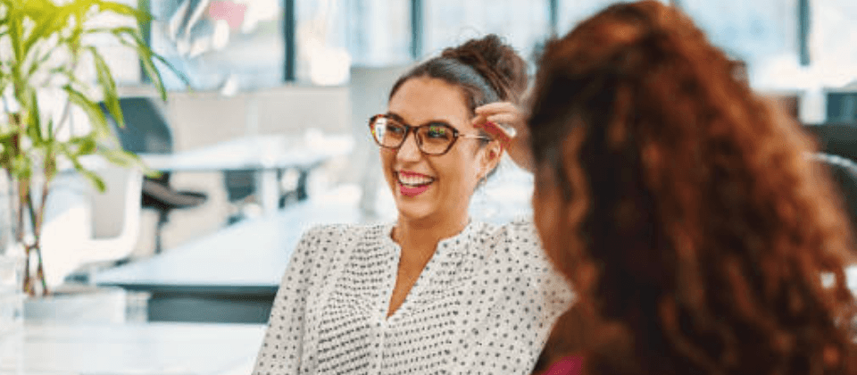 Smiling woman with glasses in a group discussion