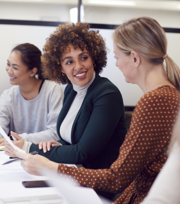 Employees in a meeting having a joyful discussion
